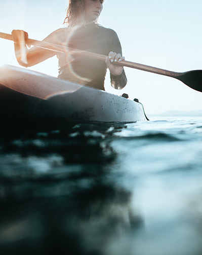 close up of a woman canoeing on a lake