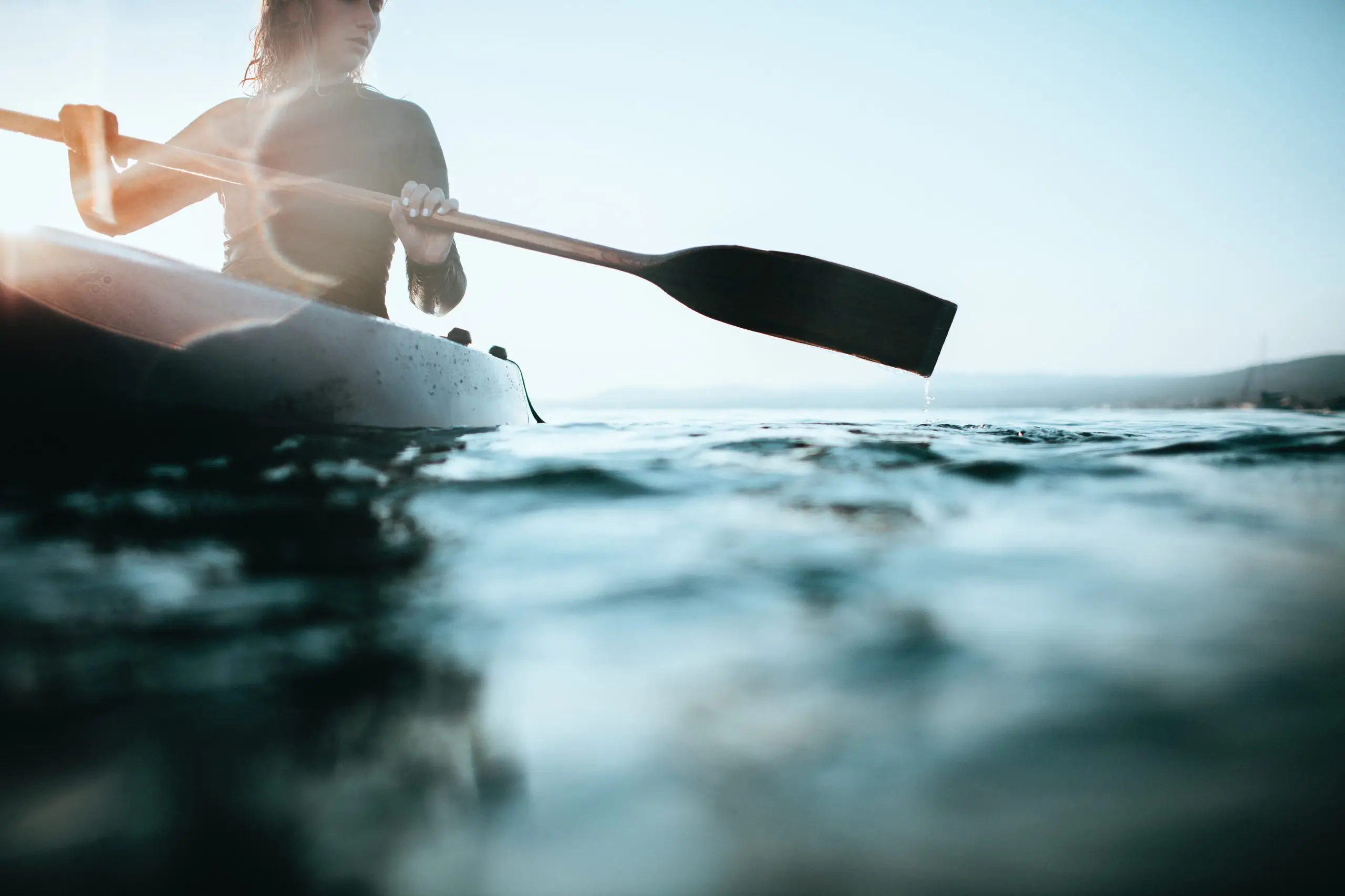 close up of a woman canoeing on a lake